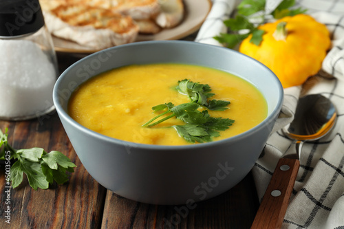 Concept of tasty food with pumpkin soup on wooden table