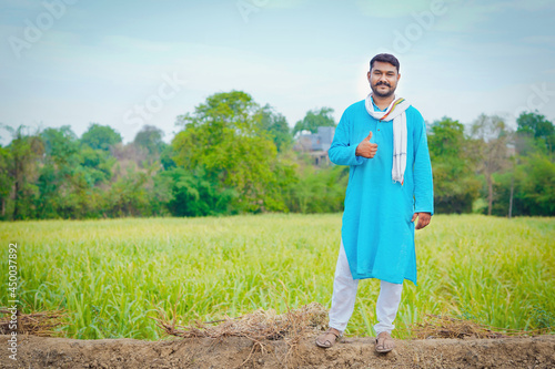 indian farmer at sugarcane field