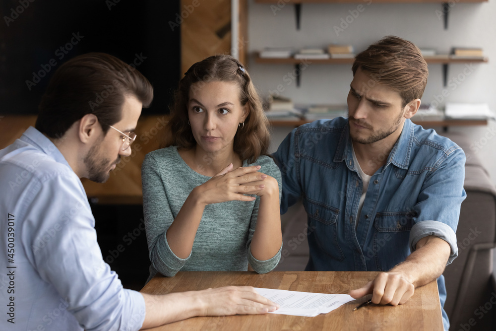Couple of angry tenants having dispute with real estate agent, discussing complaint with lawyer, consulting legal expert about mistakes in document, wrong mortgage agreement. Cheated clients concept Couple of angry tenants having dispute with real estate agent, discussing complaint with lawyer, consulting legal expert about mistakes in document, wrong mortgage agreement. Cheated clients concept