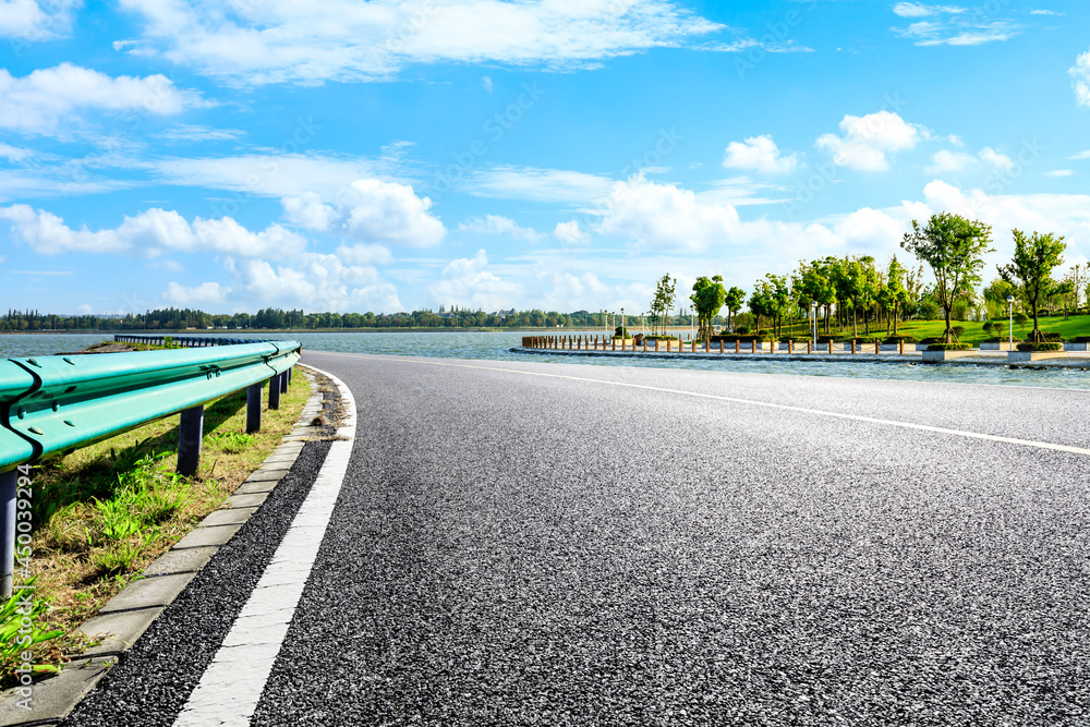 Asphalt road and park natural scenery in spring, Asia