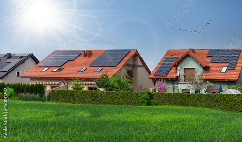 Row houses with solar panels, sunny sky. ECO Residential.