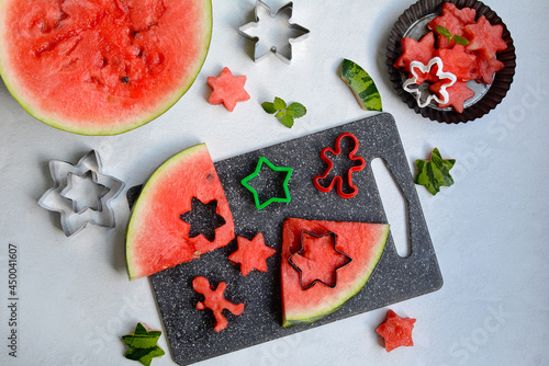 The flesh of the watermelon is cut into asterisks. Forms for baking cookies. Flat composition, top view
