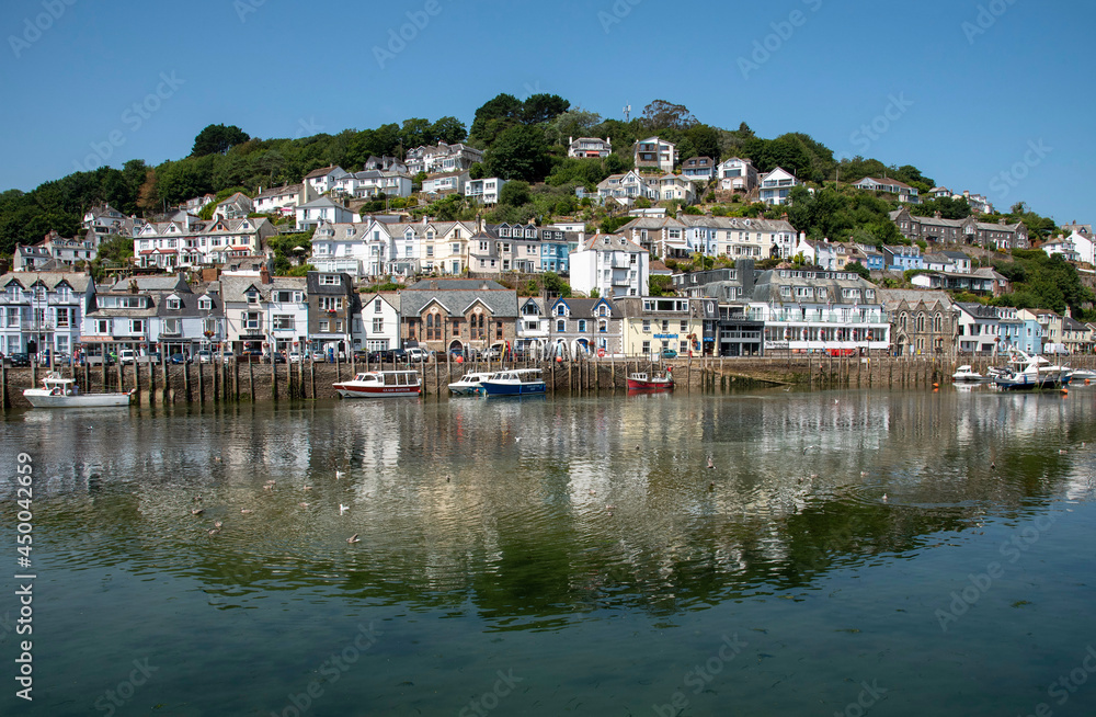 West Looe, Cornwall, England, UK. Properties reflected in the Looe River on  an incoming tide at West Looe a popular holiday resort.