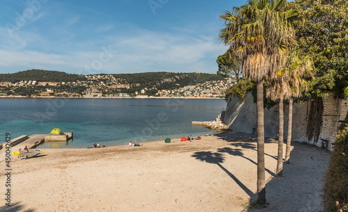 holiday-maker and boats on the beach photo