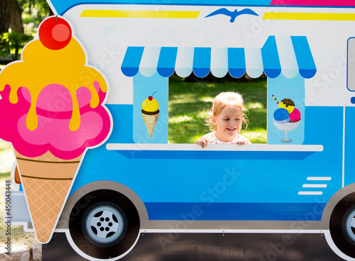 Child pretends to sell ice cream from an ice cream van