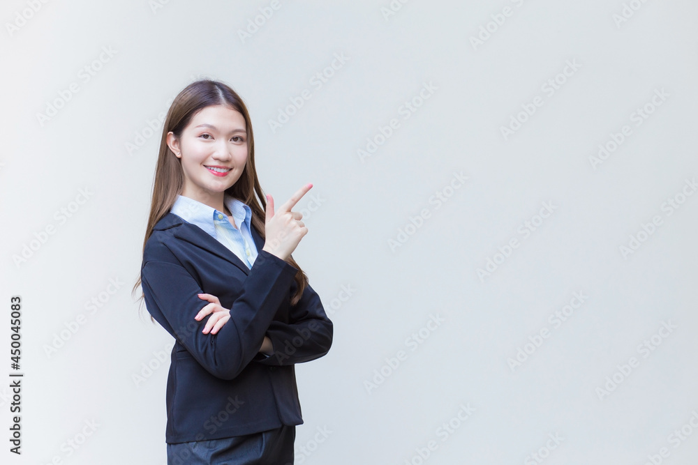 Asian professional business woman who has long hair wears black formal suit with blue shirt while she arm crossing and smiling happily on white background. Asian professional business woman who has long hair wears black formal suit with blue shirt while she arm crossing and smiling happily on white background.