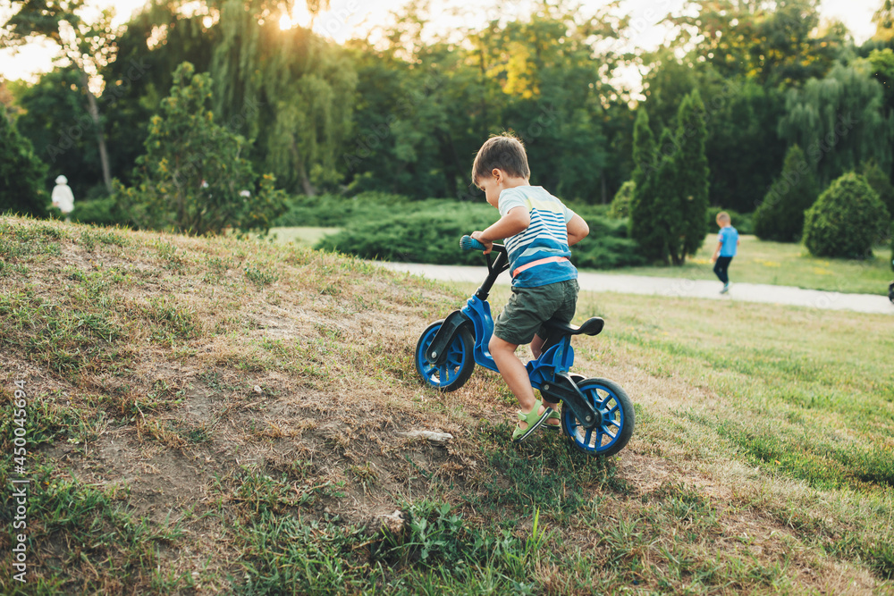 Beautiful boy in a field on bike. Outdoor recreation. Sport, healthy lifestyle. Outdoor summer fun. Beautiful boy in a field on bike. Outdoor recreation. Sport, healthy lifestyle. Outdoor summer fun.
