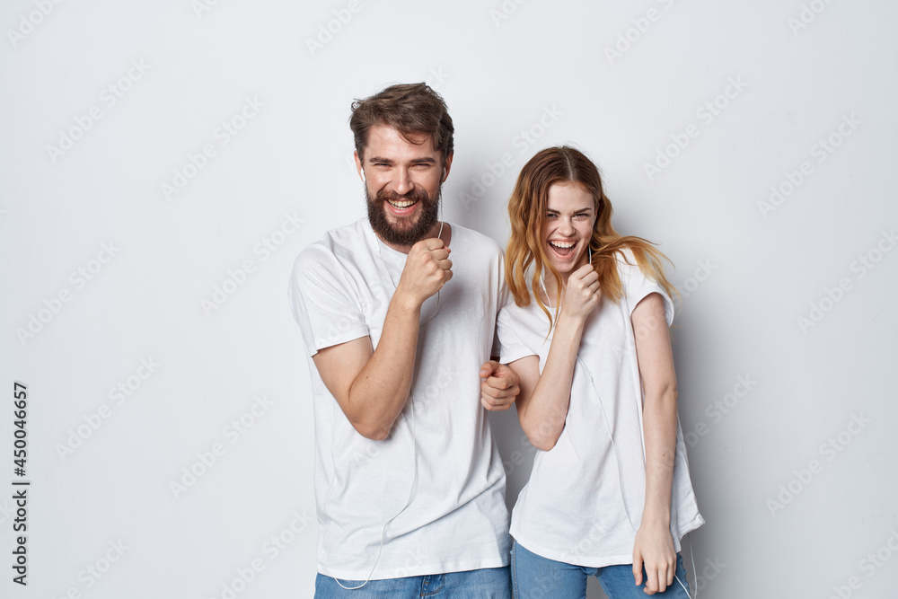 young couple in white t-shirts fun entertainment friendship positive young couple in white t-shirts fun entertainment friendship positive