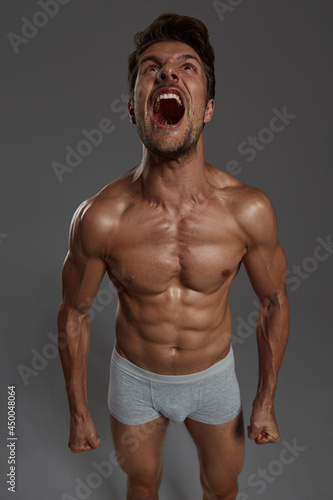 Screaming european man with naked sportive torso