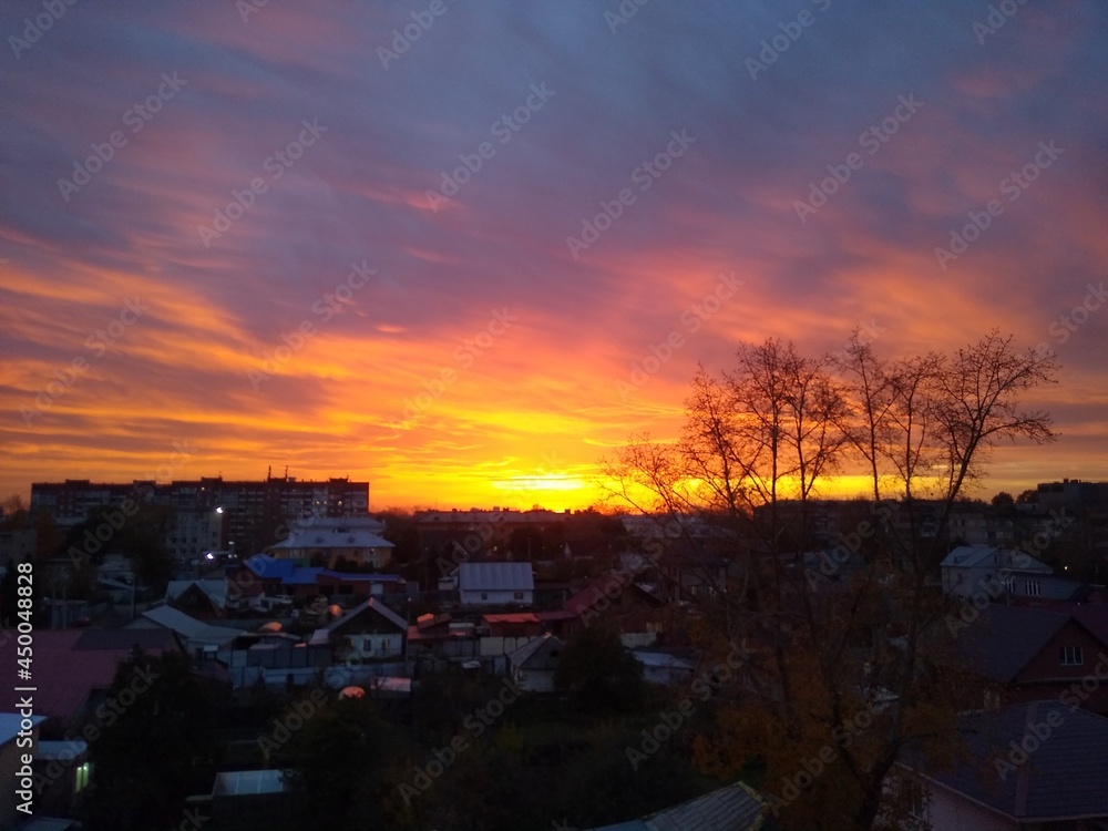 beautiful sunset in the city with heavy orange clouds. High quality photo beautiful sunset in the city with heavy orange clouds. High quality photo