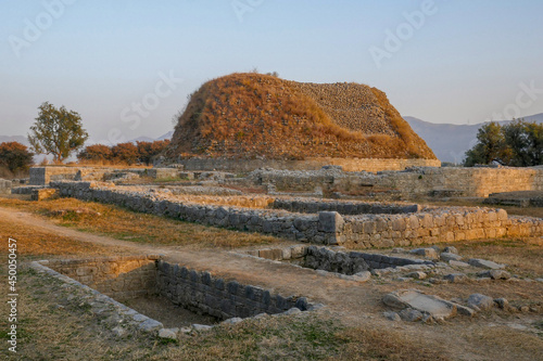Landscape view at sunset of the buddhist ruins of Dharmarajika, the Great Stupa in ancient Taxila, Punjab, Pakistan, a UNESCO World Heritage site photo