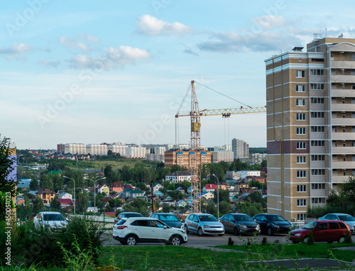 View of a new residential neighborhood in the city of Cheboksary, on the area of private houses and a construction crane in the foreground.
