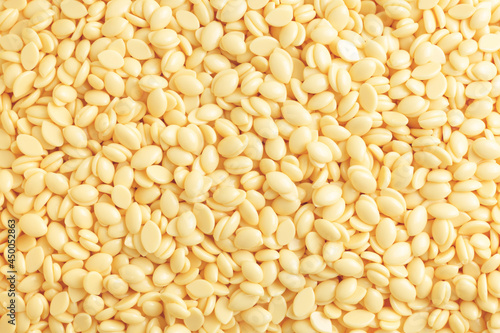 Natural depilatory wax bean granules. Texture background, hair removal.