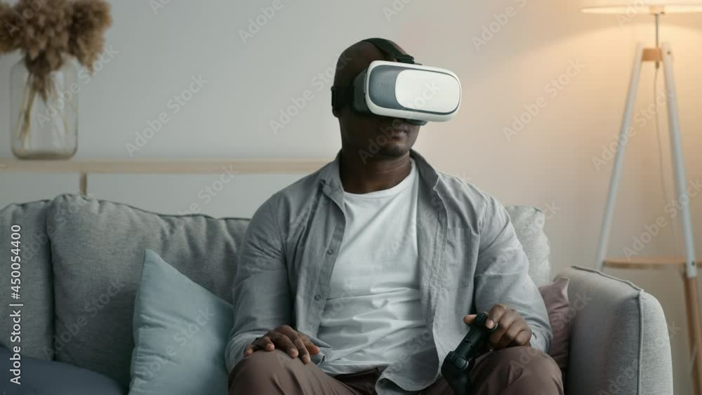 Black Man Wearing VR Glasses Losing Playing Videogame At Home Black Man Wearing VR Glasses Losing Playing Videogame At Home
