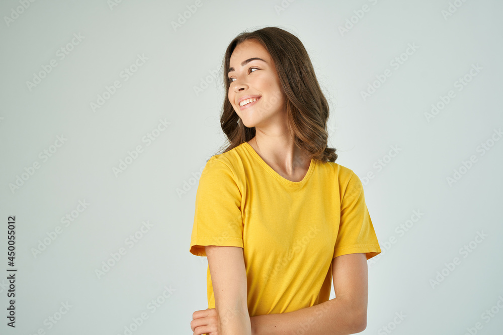 cheerful brunette in a yellow t-shirt posing fashionable hairstyle smile model cheerful brunette in a yellow t-shirt posing fashionable hairstyle smile model
