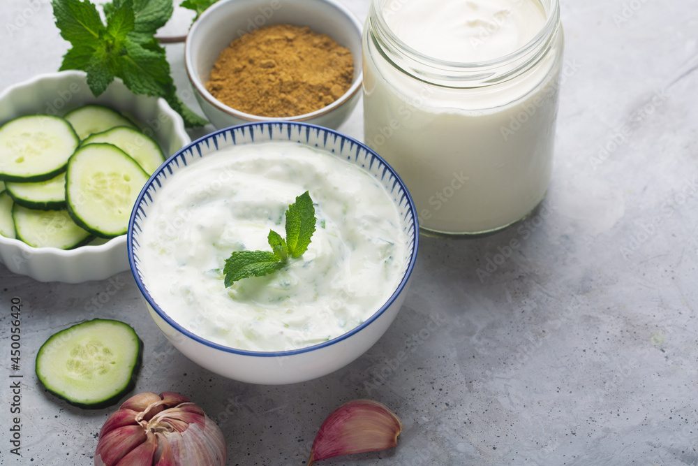 Traditional Indian Raita with Dahi in a bowl, served with mint Traditional Indian Raita with Dahi in a bowl, served with mint