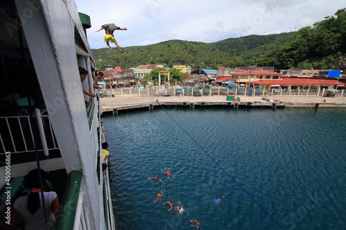 jumping from a ferry boat in Romblon, Philippines photo