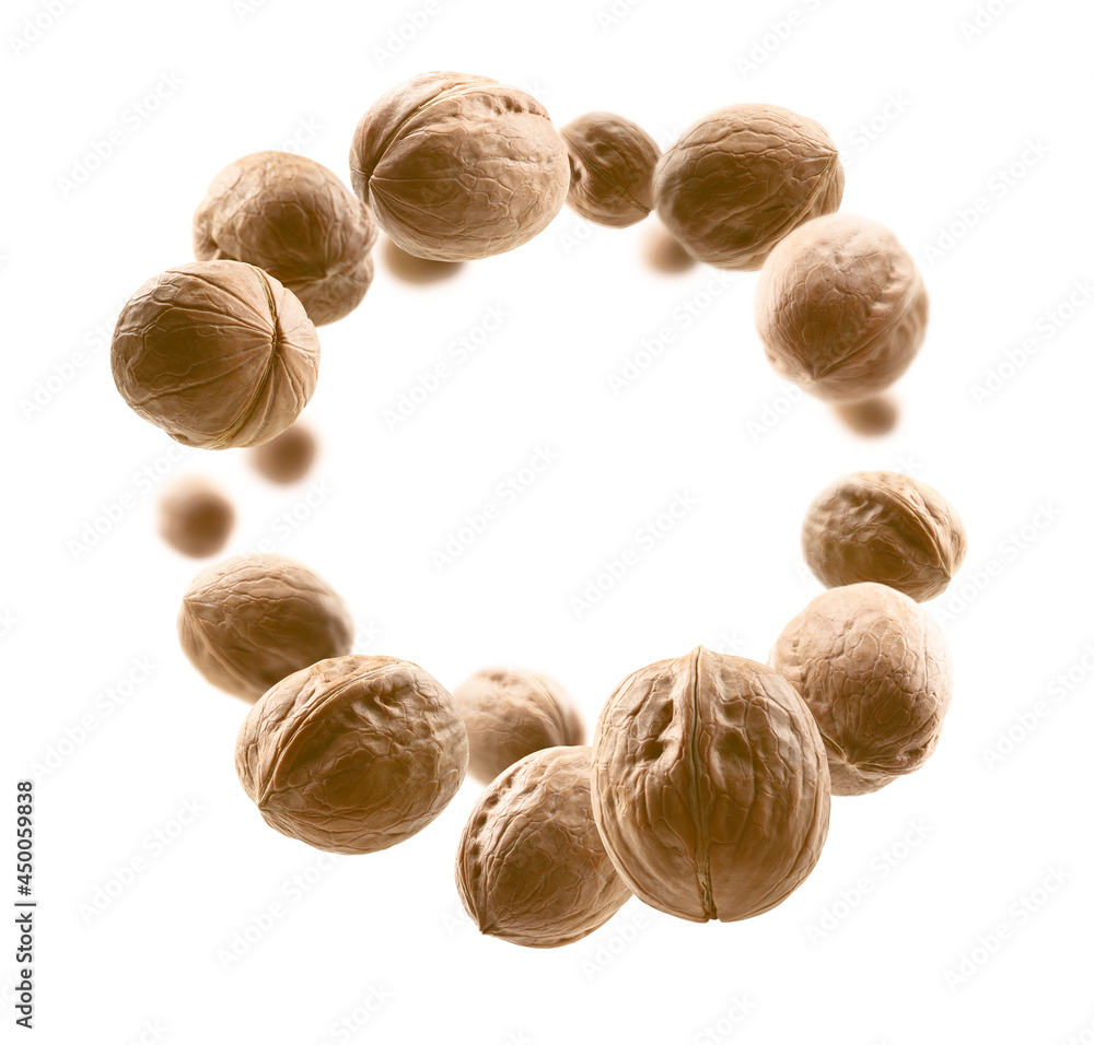 Whole walnuts levitate on a white background Whole walnuts levitate on a white background