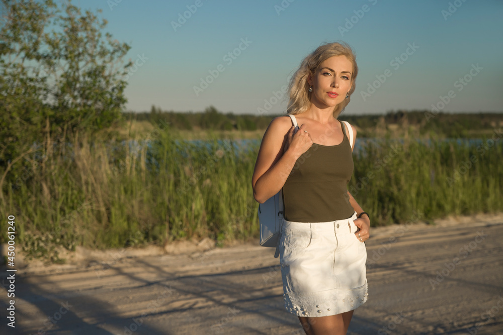Woman in casual dress and with backpack