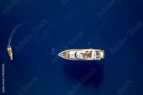 Aerial top down view of a luxury yacht over blue ocean © moofushi