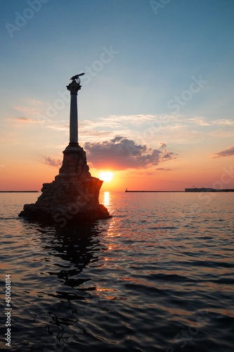 sunset over the sea with Monument to the Sunken Ships