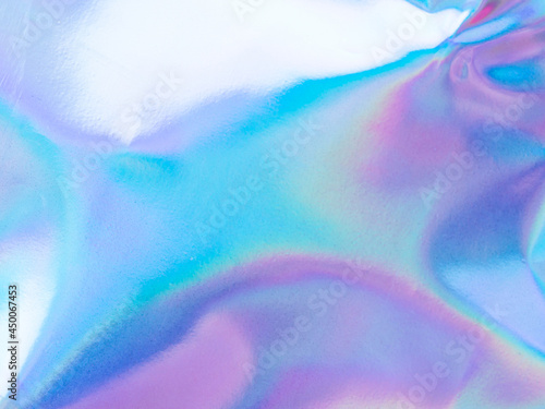 Beautiful holographic rainbow abstract background in pastel and neon color design. Real photography shot of holographic foil for creative project - design fashion, cover, book, printing. Copy space photo