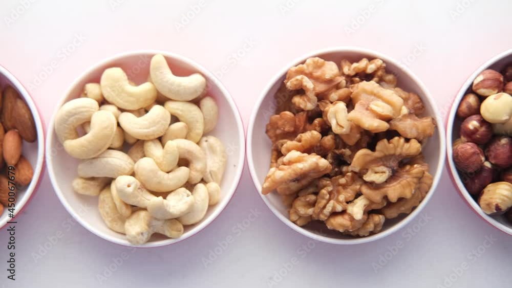 peanut, hazelnut walnut , cashew nut and almond in a container on white peanut, hazelnut walnut , cashew nut and almond in a container on white