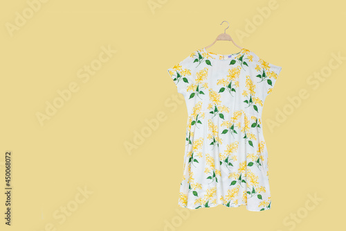 Woman blouse with summer blouse cotton on yellow background. photo