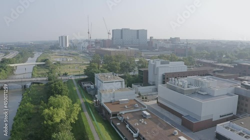 A summer morning aerial establishing shot of the Columbus, Ohio area. The Olentangy River and trail below with the Ohio State campus in the far distance.  	 photo