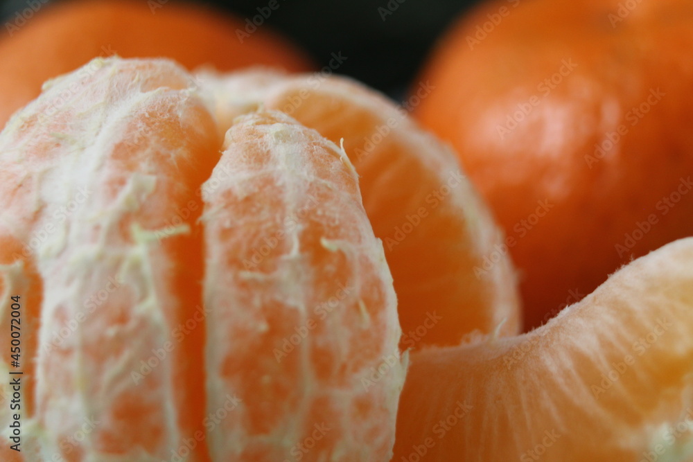 slice a piece of tangerine close-up. Orange citrus with white veins. food close-up