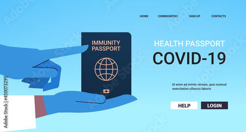 doctor in gloves holding global immunity passport risk free covid-19 re-infection coronavirus immunity concept