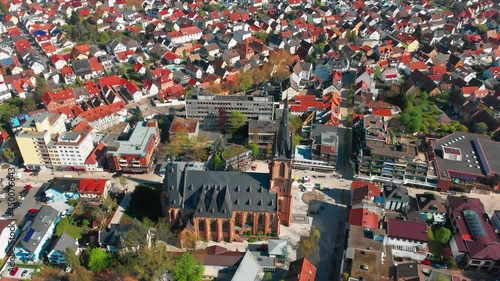 Beautiful morning top view of the central part of Viernheim. Old catholic cathedral. Orange tiled roofs of houses. Germany. photo