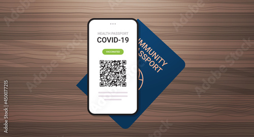 digital vaccinate certificate and global immunity passport on wooden table coronavirus immunity concept