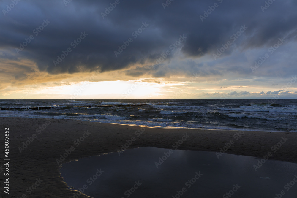 cloudy sunset over the sea, menacing sky and rough waves