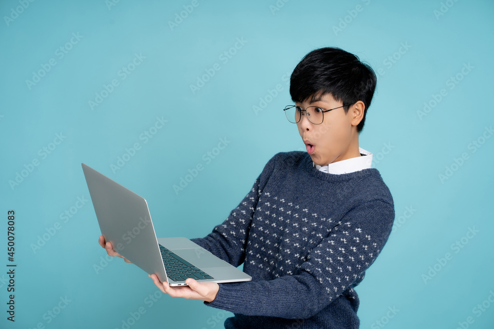 Wow, Asian businessman shocked and holding a laptop computer in the studio. Wow, Asian businessman shocked and holding a laptop computer in the studio.