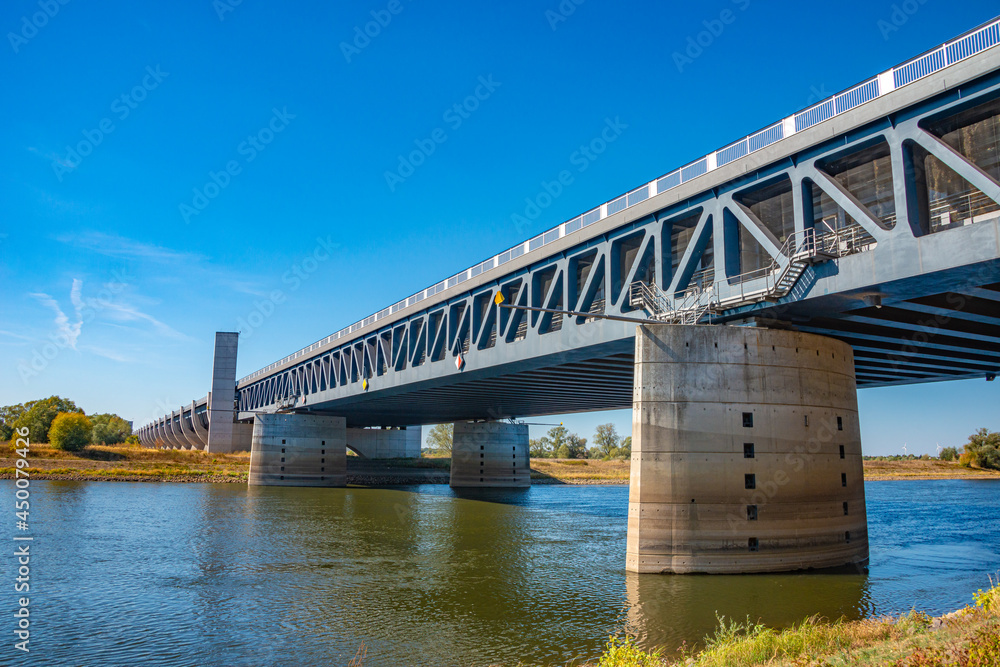View over a famous wonder water bridge for ship navigation canal near Magdeburg at Autumn colors, sunny day and blue sky, Magdeburg, Germany.