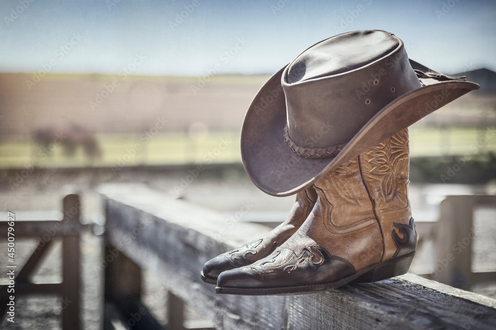 Cowboy hat and boots at ranch stables, country music festival live concert or line dancing concept - obrazy, fototapety, plakaty 