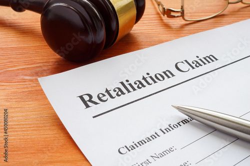 Fotografía Retaliation claim lying on the desk with gavel.
