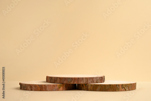 Fototapeta Naklejka Na Ścianę i Meble -  Round wooden podium on beige background for product.