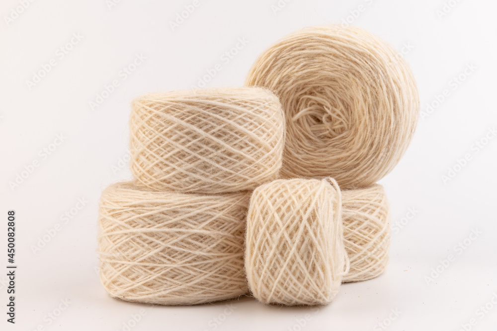 balls of light woolen thread on white background. natural wool. knitting. background balls of light woolen thread on white background. natural wool. knitting. background