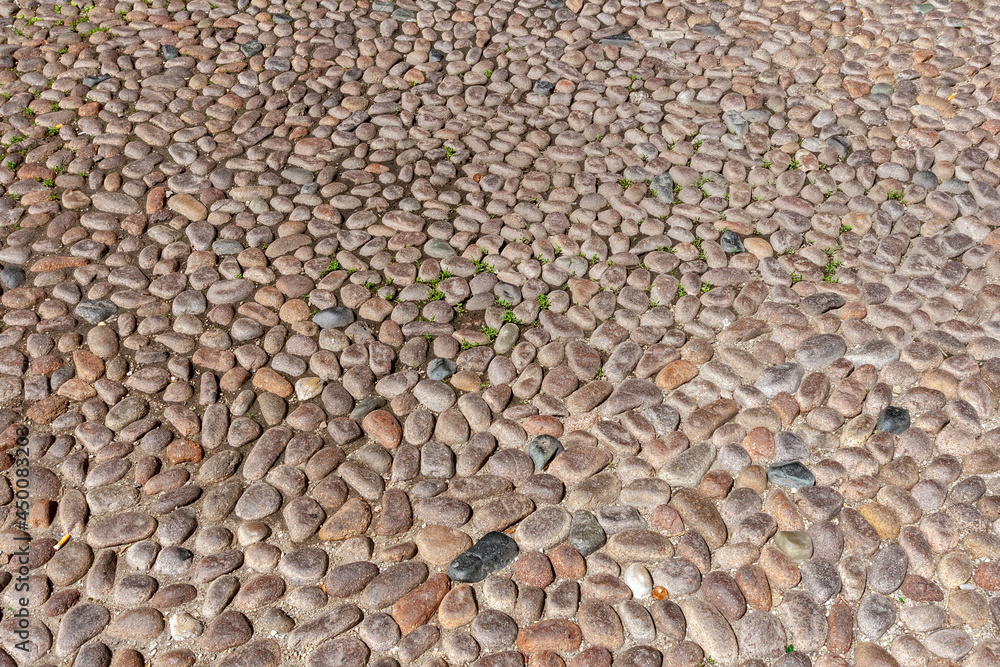Pebble pavement in Bologna on a summer day Pebble pavement in Bologna on a summer day