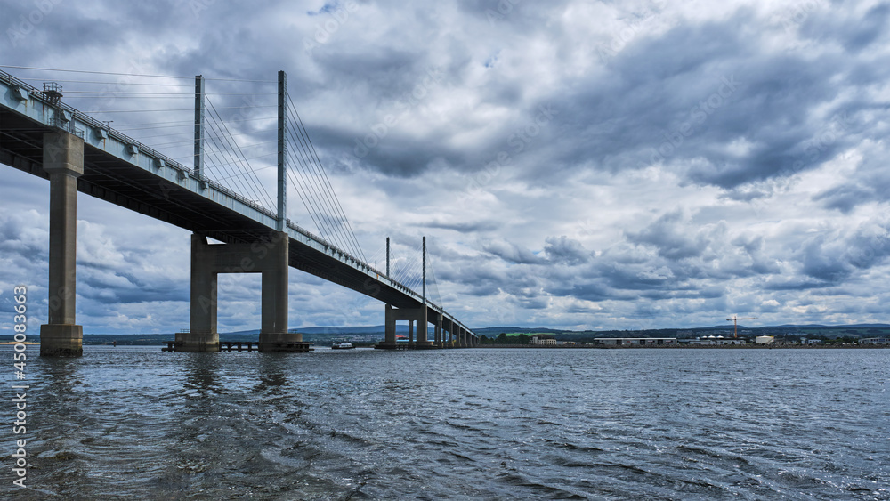 Kessock Bridge over the Moray Firth at Inverness in the Highlands with a boat sailing under the bridge