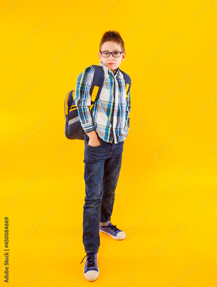 the little pupil wearing style clothes stands with folded arms the little pupil wearing style clothes stands with folded arms