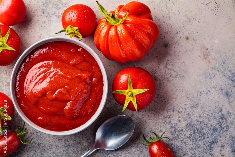 Homemade tomato sauce in gray bowl. Cooking from summer vegetables concept. Homemade tomato sauce in gray bowl. Cooking from summer vegetables concept.