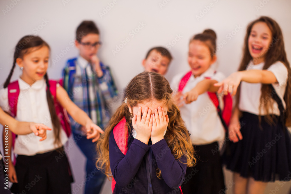 The classmates point to the boy and laugh at him