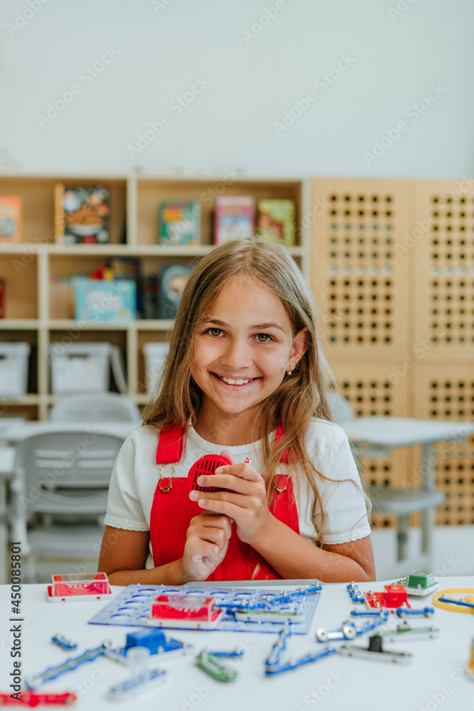 Teenage girl constructing electrical mechanism in the classroom Teenage girl constructing electrical mechanism in the classroom