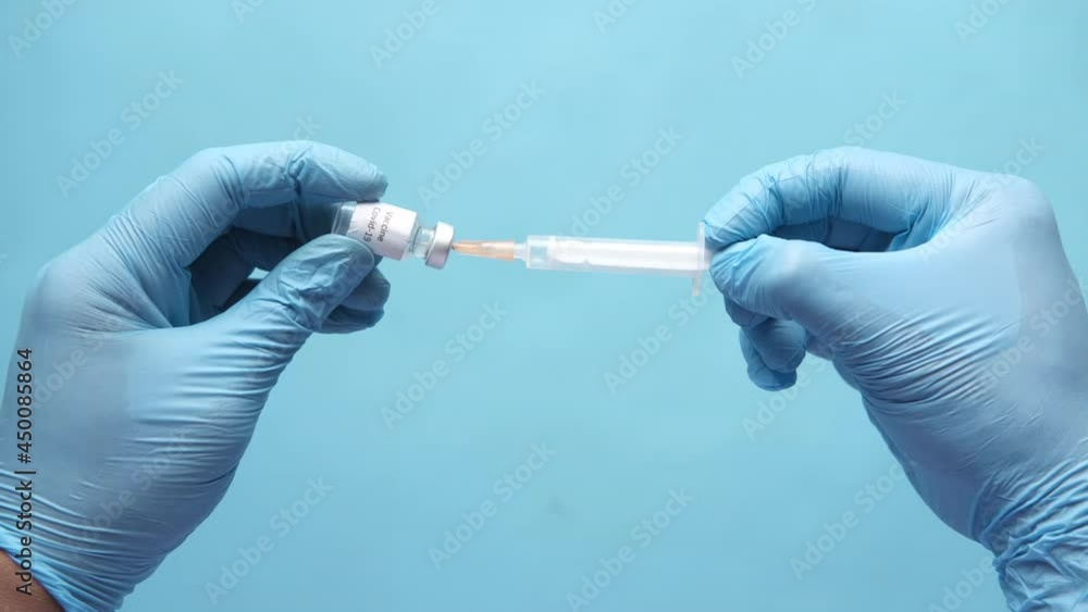 hand in blue latex gloves fill in syringe with medicine isolated on white hand in blue latex gloves fill in syringe with medicine isolated on white
