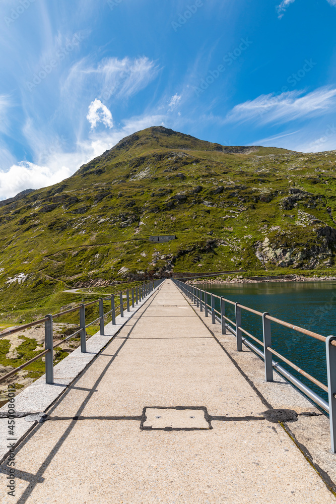 Panorama from the Gotthard pass in Ticino of the Swiss Alps on a summer's day with sunshine and blue skies. Panorama from the Gotthard pass in Ticino of the Swiss Alps on a summer's day with sunshine and blue skies.