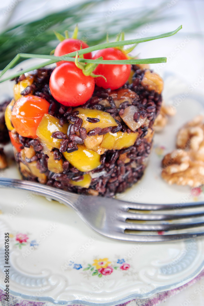 Black risotto with tomatoes peppers and walnuts Black risotto with tomatoes peppers and walnuts