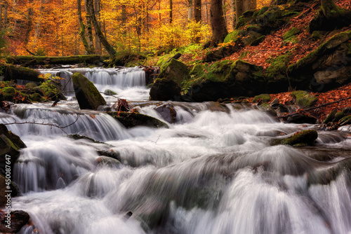 Amazing nature landscape with colored autumn forest and mountain creek, outdo...